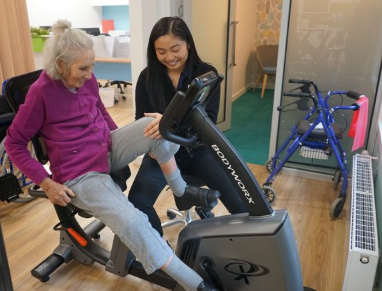 Gym Trainer Guiding Old Women